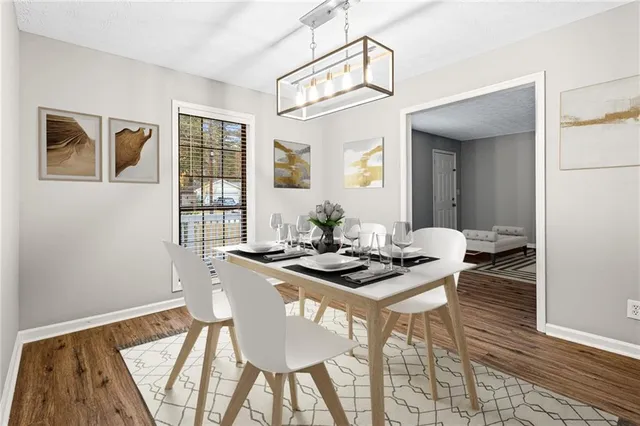 a view of a dining room with furniture and wooden floor