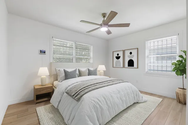 a bedroom with a large bed and a window