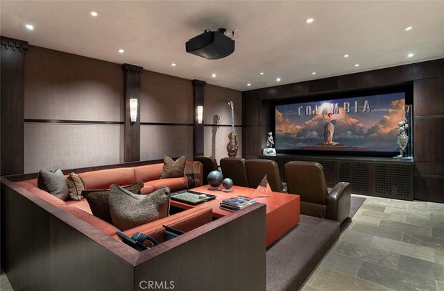 a living room with furniture a large window and stainless steel appliances