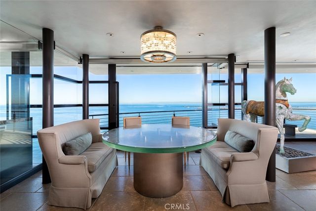 a living room with furniture and a floor to ceiling window