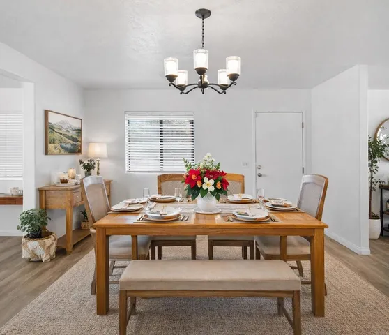 a living room with furniture a rug and a flat screen tv