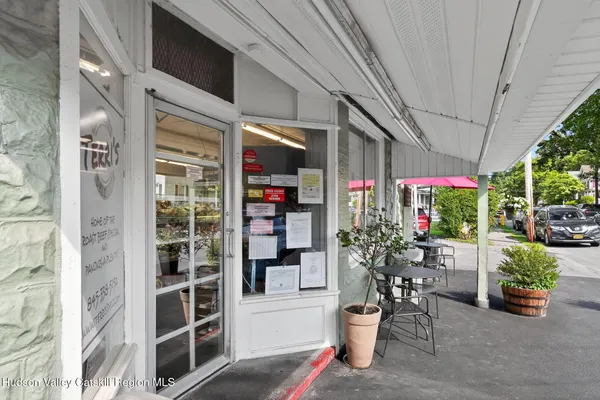 a hallway view with a dining table and chairs