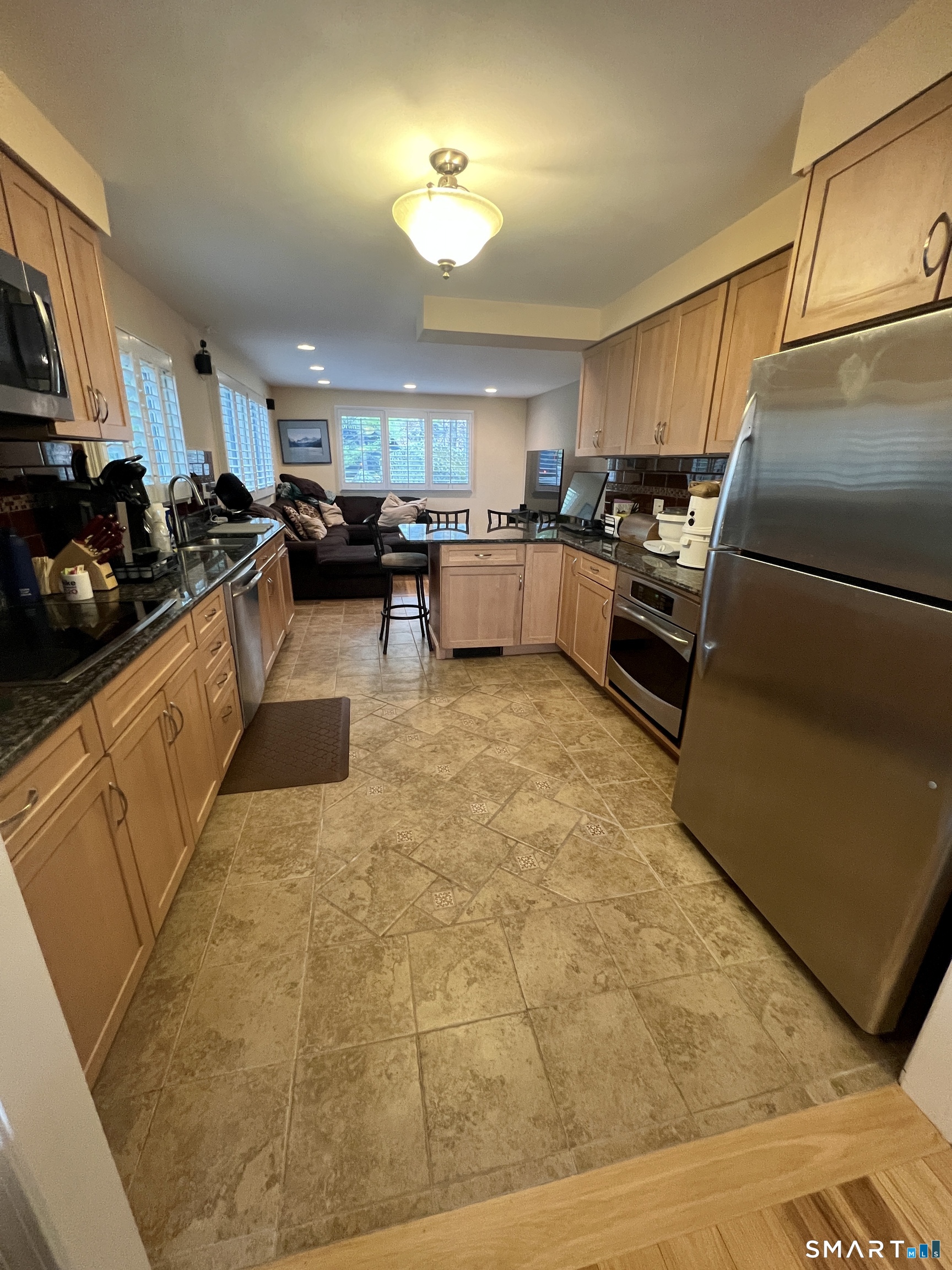 305 Cliffside Drive Torrington, CT 06790 - Photo 6 of 25 a kitchen with refrigerator and cabinets