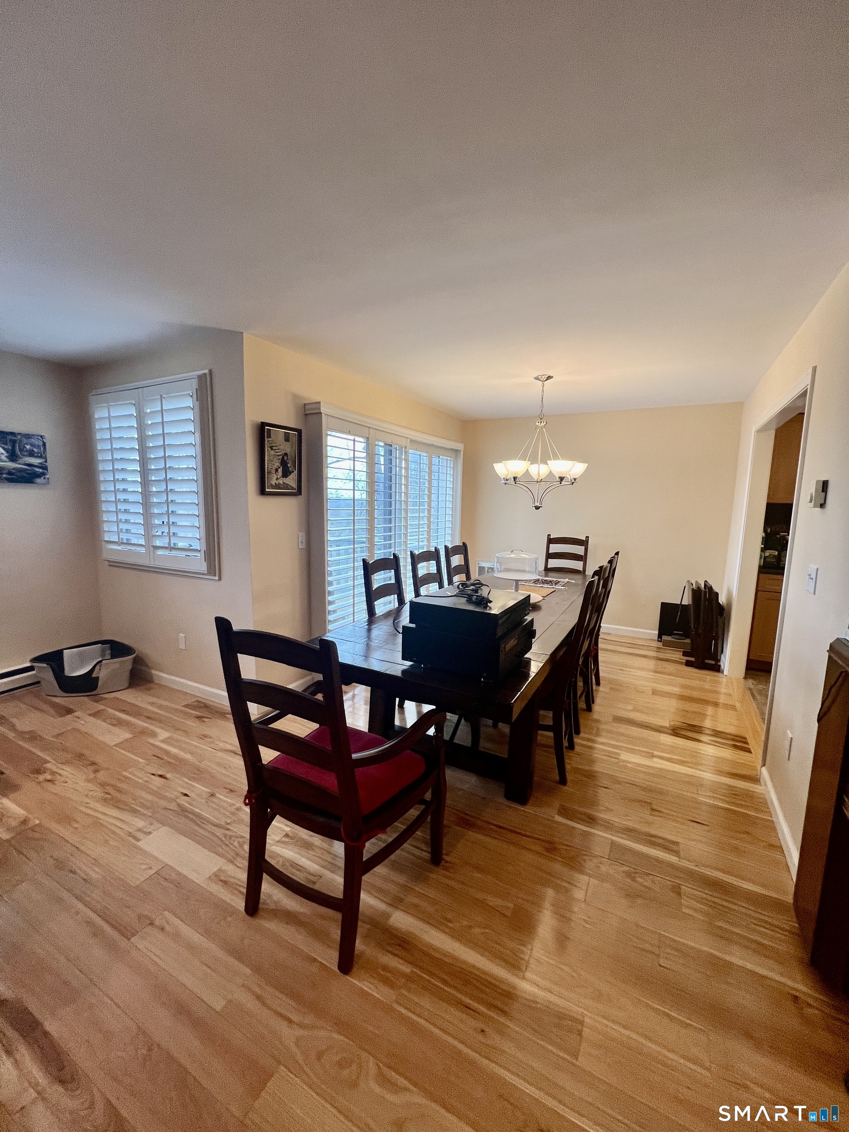 305 Cliffside Drive Torrington, CT 06790 - Photo 10 of 25 a living room with furniture and a dining table with wooden floor