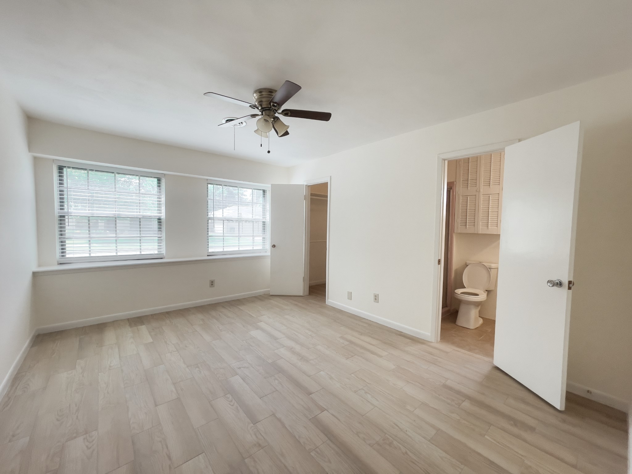 7710 Romney Road Houston, TX 77036 - Photo 11 of 31 a view of an empty room with wooden floor and a window
