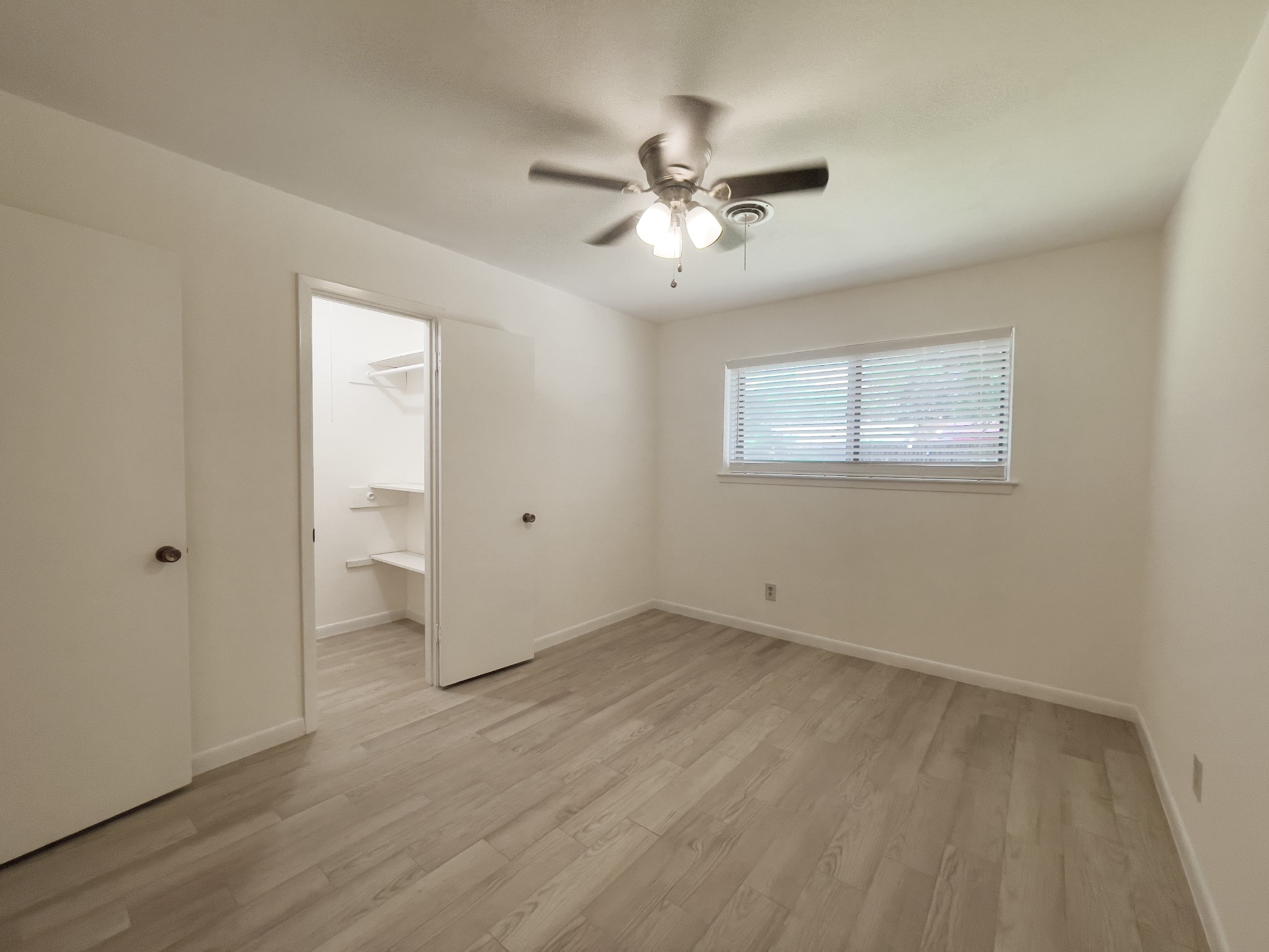 7710 Romney Road Houston, TX 77036 - Photo 17 of 31 wooden floor in an empty room with a window