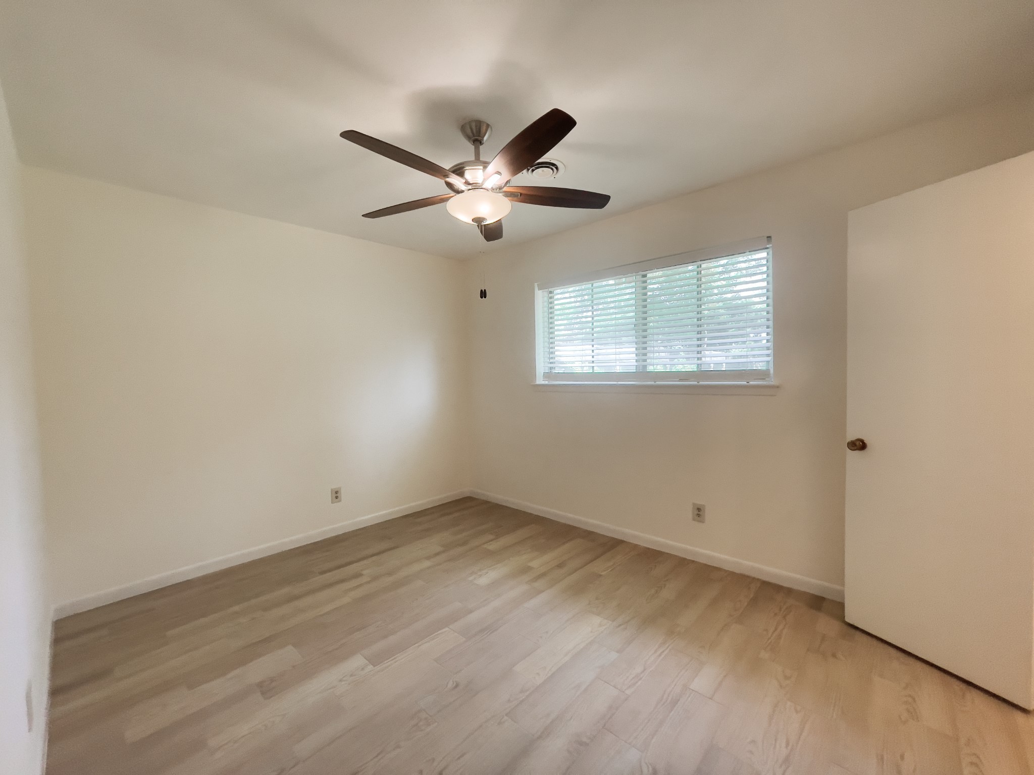 7710 Romney Road Houston, TX 77036 - Photo 19 of 31 a view of an empty room with a window