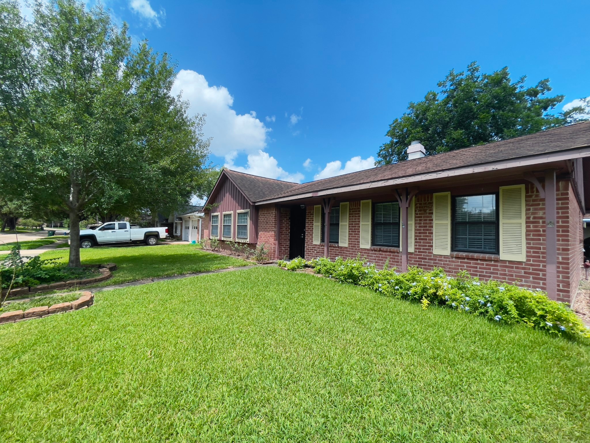 7710 Romney Road Houston, TX 77036 - Photo 30 of 31 a view of an house with backyard space and garden