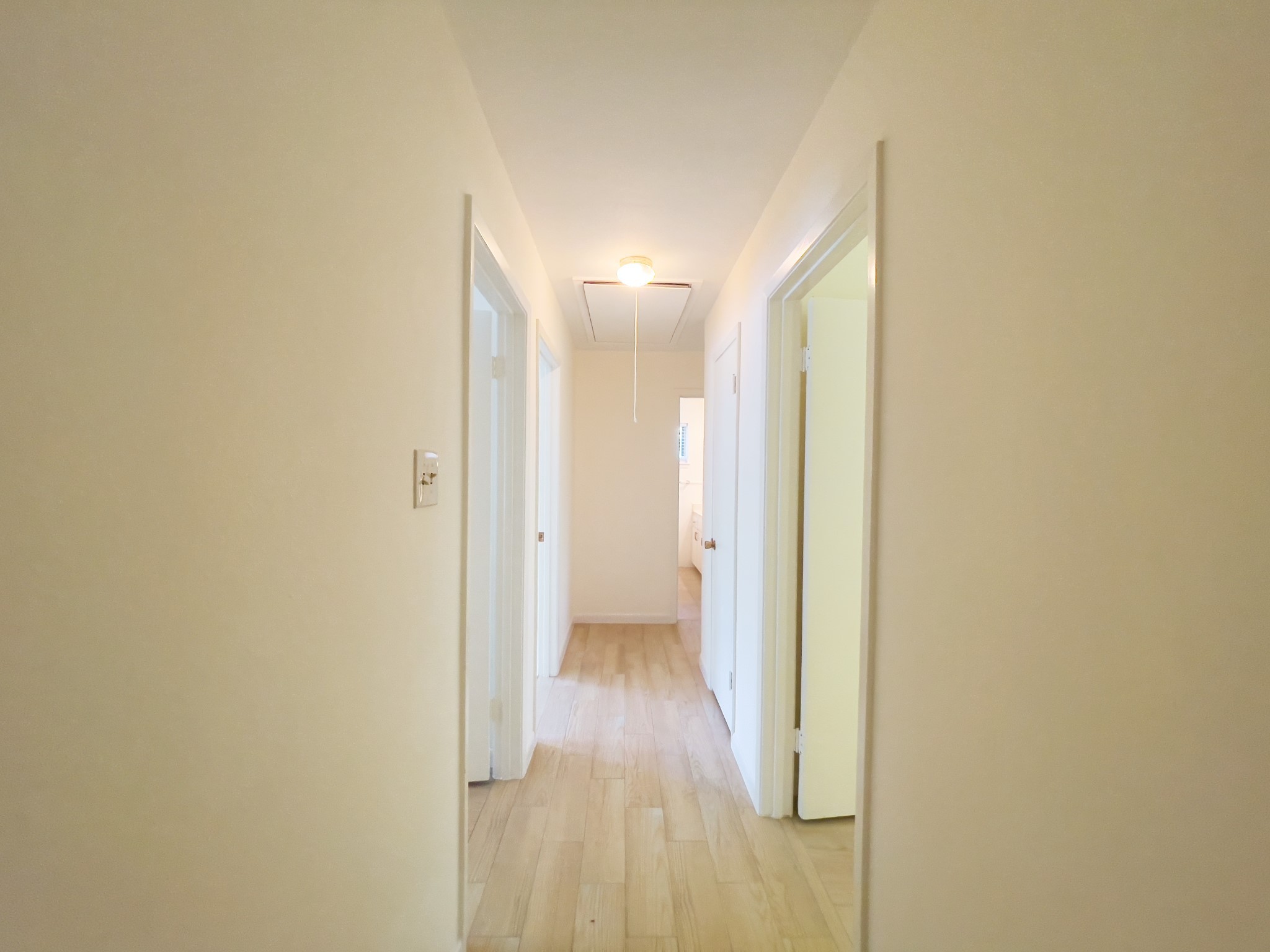 7710 Romney Road Houston, TX 77036 - Photo 8 of 31 a view of a hallway with wooden floor