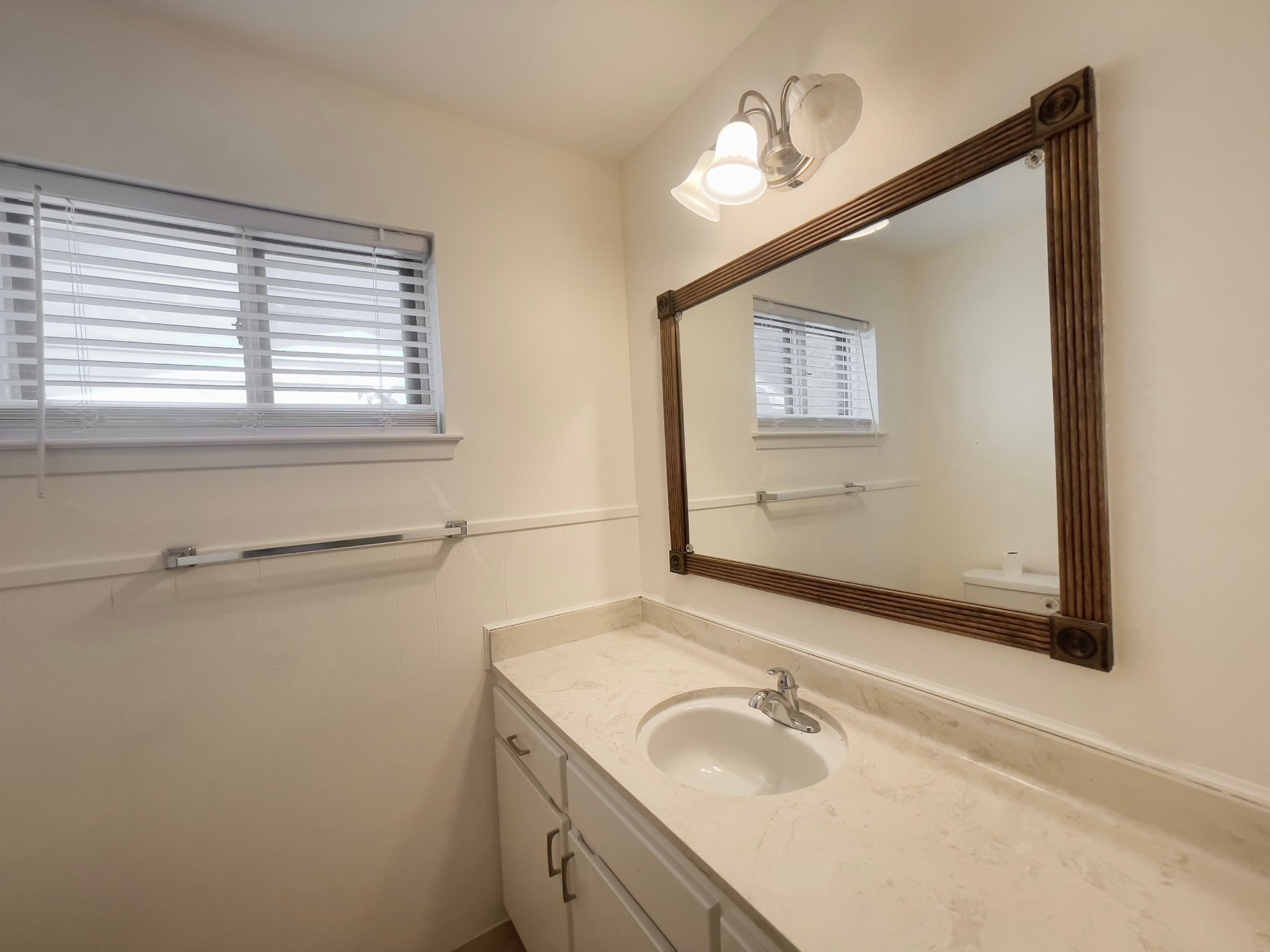 7710 Romney Road Houston, TX 77036 - Photo 9 of 31 a bathroom with a sink and a mirror