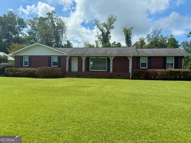 a front view of house with yard and green space