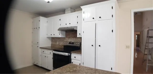 a kitchen with stainless steel appliances a refrigerator and cabinets