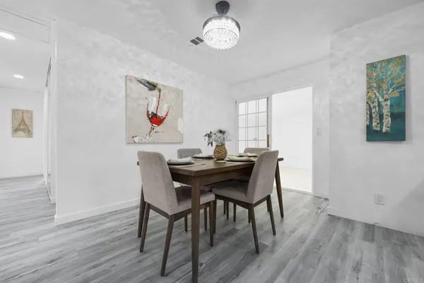a view of a dining room with furniture window and wooden floor