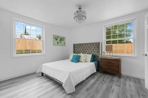 a bedroom with a bed and windows