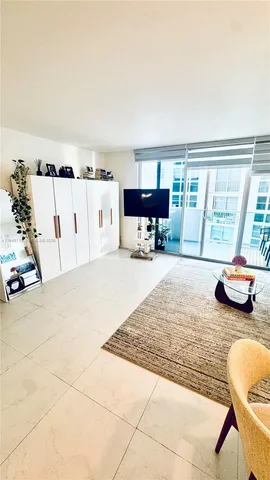 a living room with furniture a window and a table