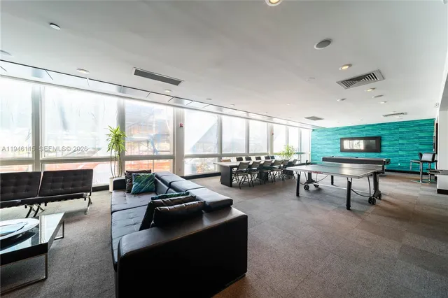 a hallway with table and chairs
