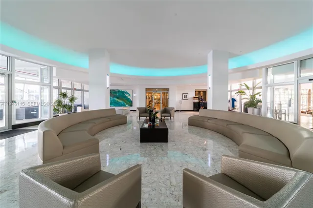 a living room with patio furniture and a garden