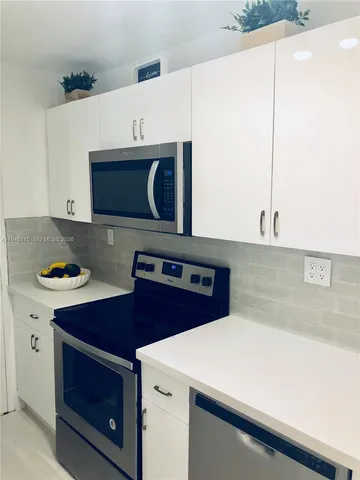 closeup view of kitchen island with cabinets and wooden floor