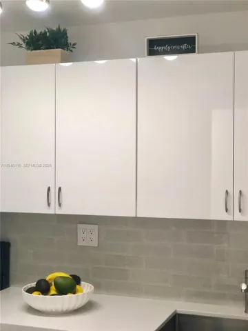 a kitchen with a sink a faucet and a stove