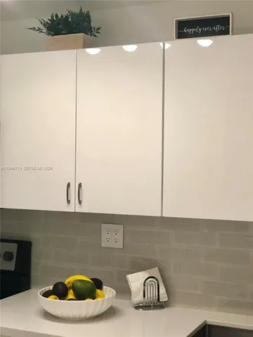 a kitchen with a sink and a stove top oven