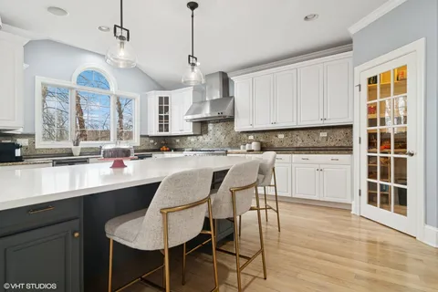 a view of a hallway with wooden floor and windows