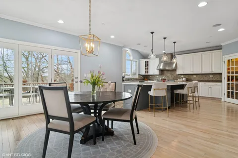 a view of a hallway with wooden floor and windows