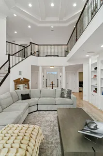 a bedroom with furniture and a large window