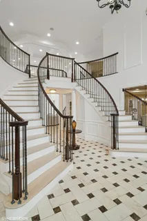 a kitchen with stainless steel appliances kitchen island granite countertop a sink and a refrigerator