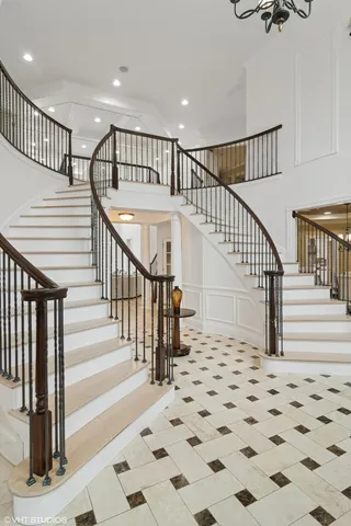 a kitchen with stainless steel appliances kitchen island granite countertop a sink and a refrigerator