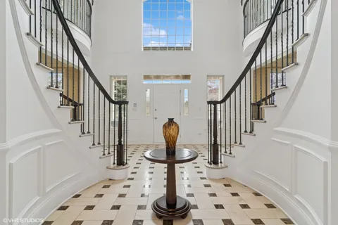 a kitchen with stainless steel appliances kitchen island granite countertop a sink a stove a dining table and chairs