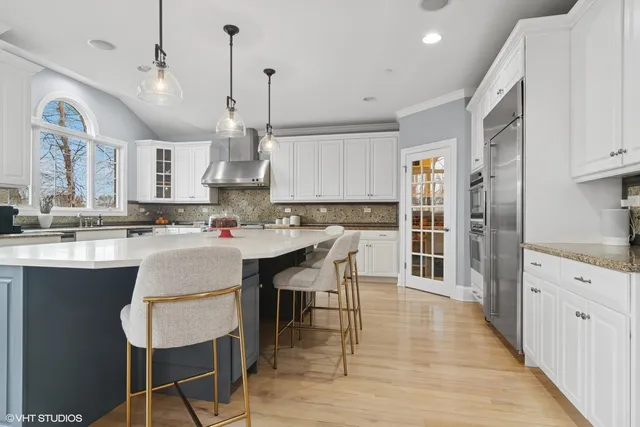 an open kitchen with dining table and wooden floors