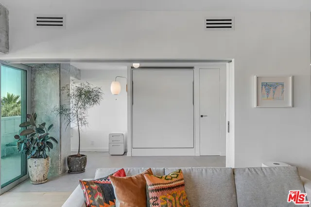 a living room with furniture and flowers