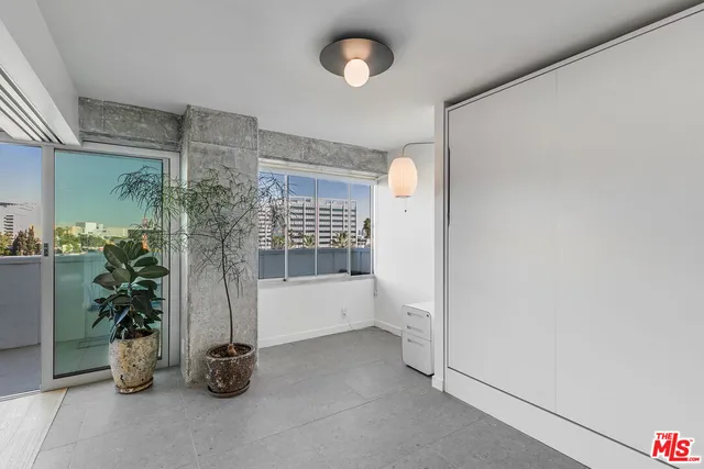 an empty room with windows and painted walls