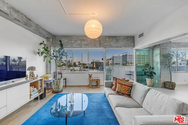 a living room with kitchen island furniture and a large window
