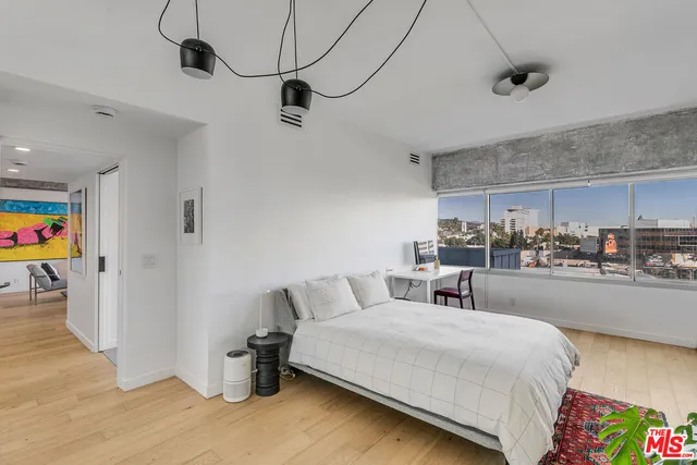 a bedroom with a bed and a view of kitchen