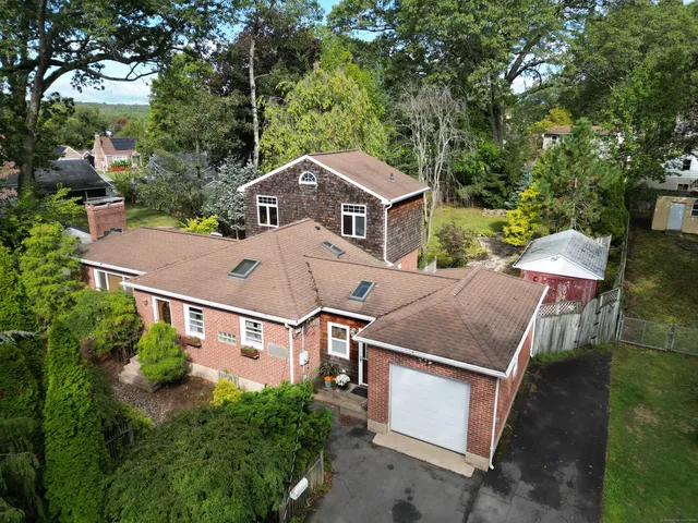 an aerial view of a house with a yard