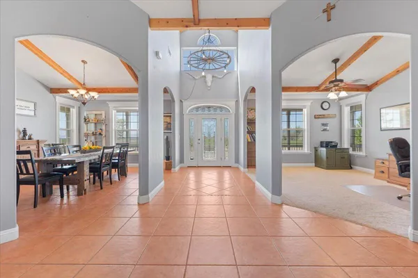 a bedroom with a bed and a chandelier fan