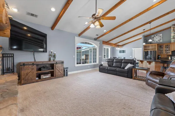 a bedroom with a large bed and a ceiling fan