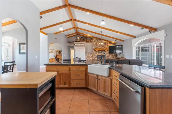a view of a backyard with table and chairs under an umbrella