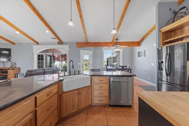 a backyard of a house with yard table and chairs