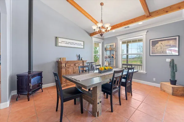 an aerial view of a house with a garden and lake view