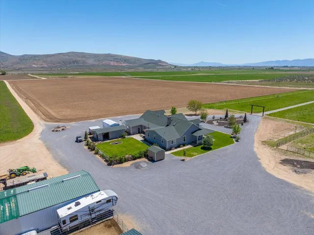 a living room with furniture a flat screen tv and kitchen view