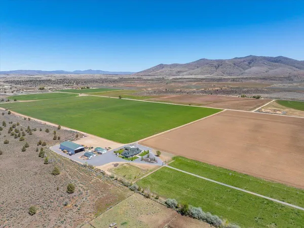 a living room with furniture a flat screen tv and floor to ceiling window