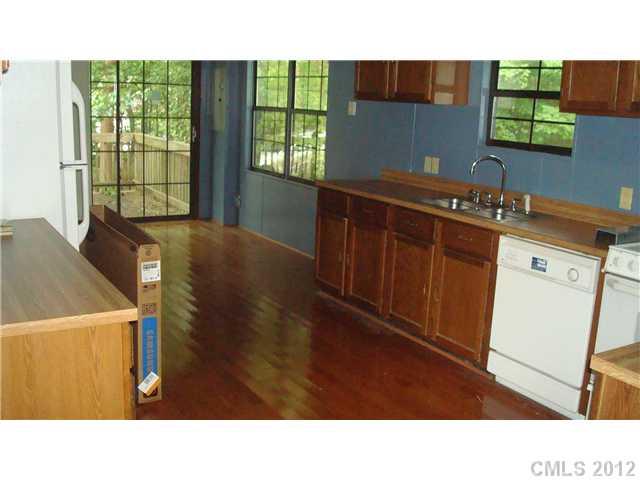 561 Bethlehem Road Statesville, NC 28677 - Photo 6 of 14 a kitchen with a sink cabinets and wooden floor