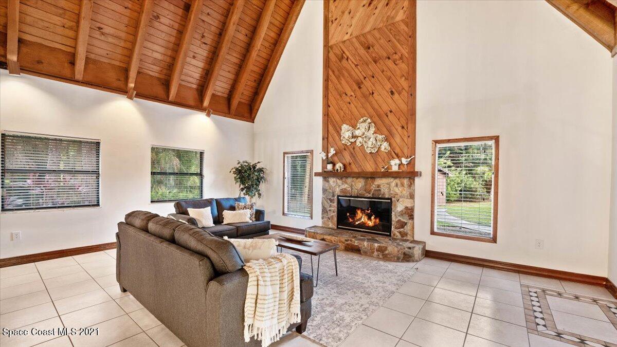 4455 Lake Washington Road Melbourne, FL 32934 - Photo 15 of 53 a living room with furniture and a fireplace