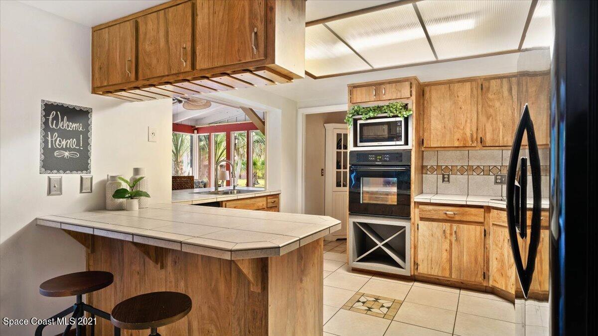 4455 Lake Washington Road Melbourne, FL 32934 - Photo 19 of 53 a kitchen with stainless steel appliances granite countertop a stove and a refrigerator