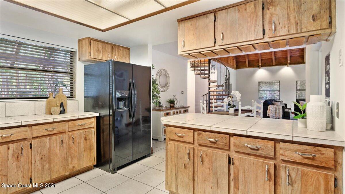 4455 Lake Washington Road Melbourne, FL 32934 - Photo 20 of 53 a kitchen with stainless steel appliances kitchen island granite countertop a refrigerator and cabinets