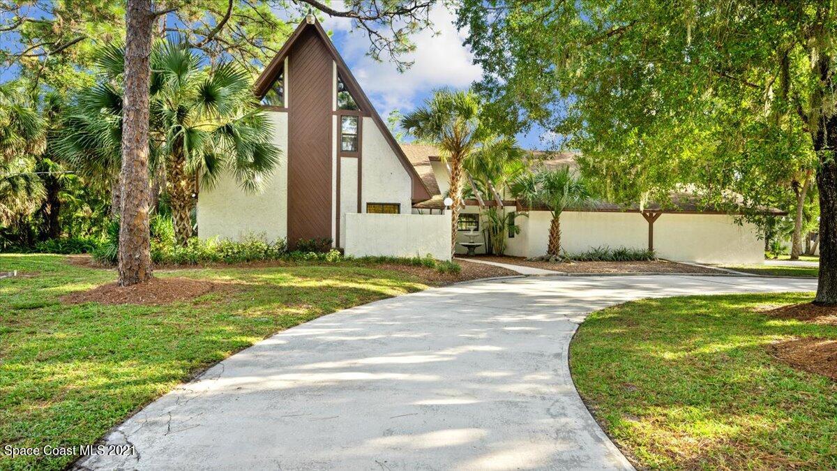 4455 Lake Washington Road Melbourne, FL 32934 - Photo 2 of 53 a front view of a house with a yard