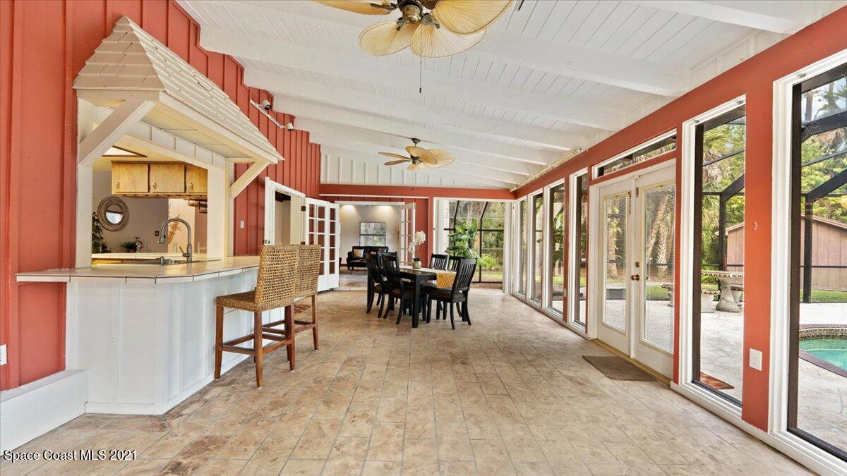 4455 Lake Washington Road Melbourne, FL 32934 - Photo 25 of 53 a dining room with furniture and a chandelier