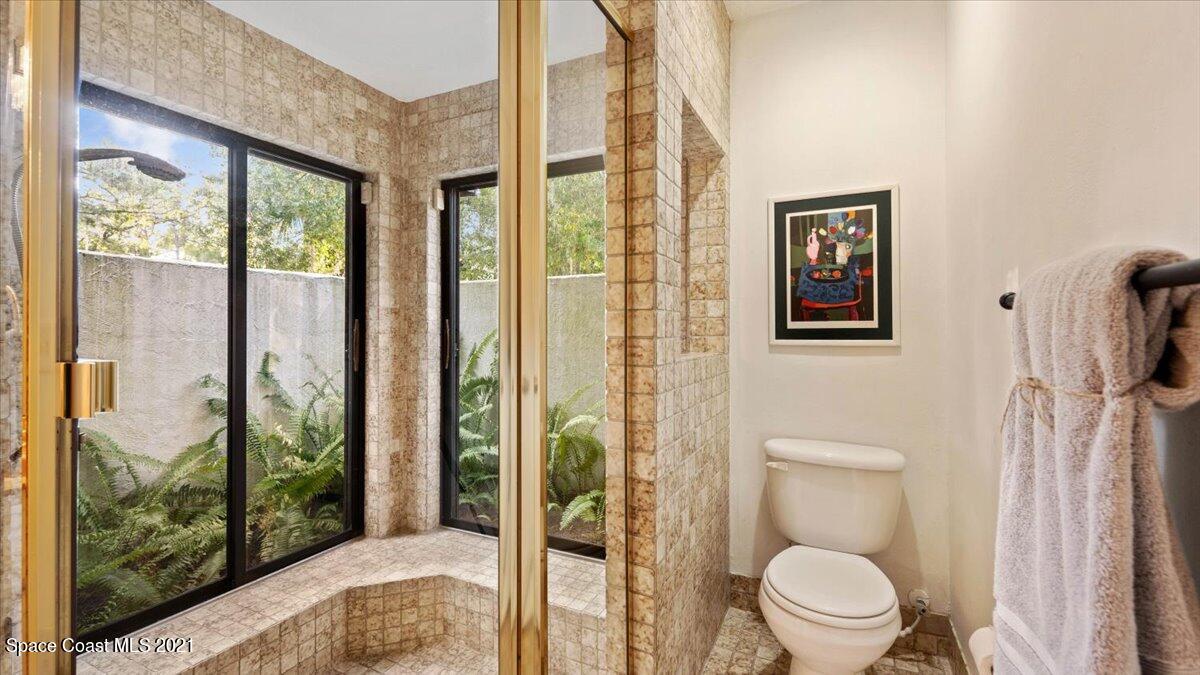 4455 Lake Washington Road Melbourne, FL 32934 - Photo 30 of 53 a bathroom with a toilet and a shower